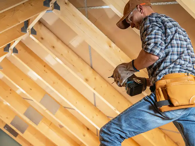 photo of a man remodeling an attic